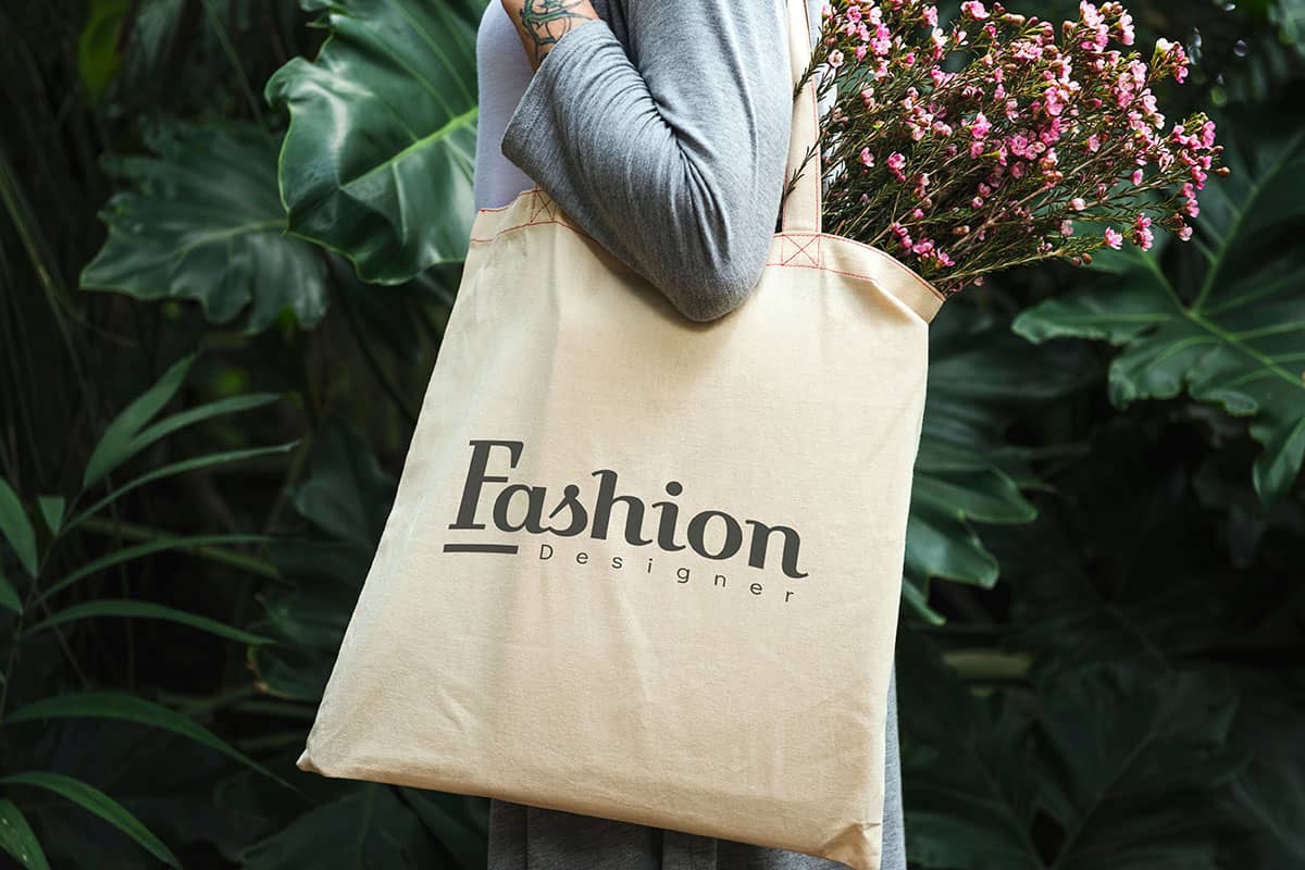 A person holding a San Antonio custom merchandise tote bag.